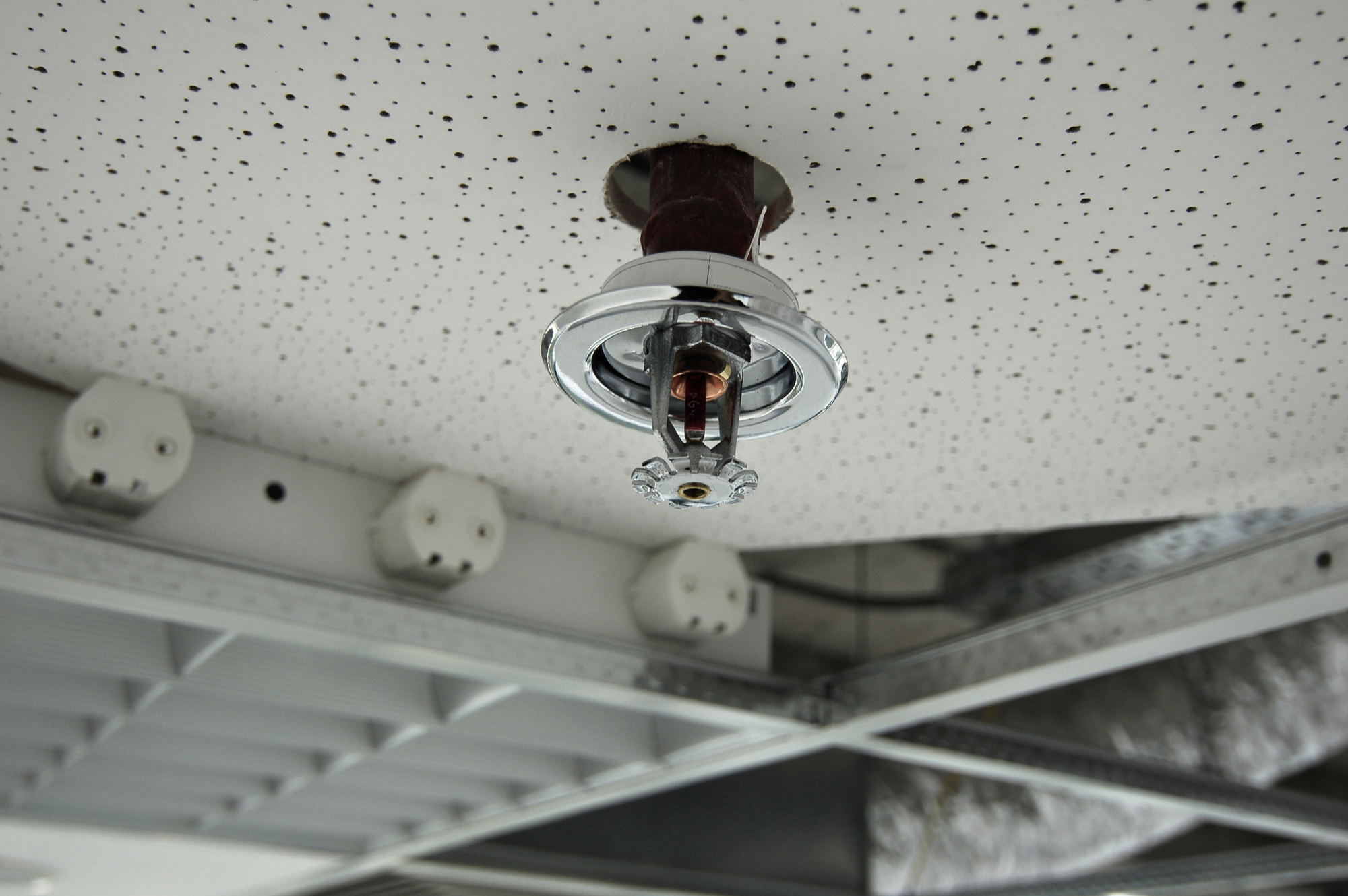 metal-sprinkler-fire-speckled-ceiling